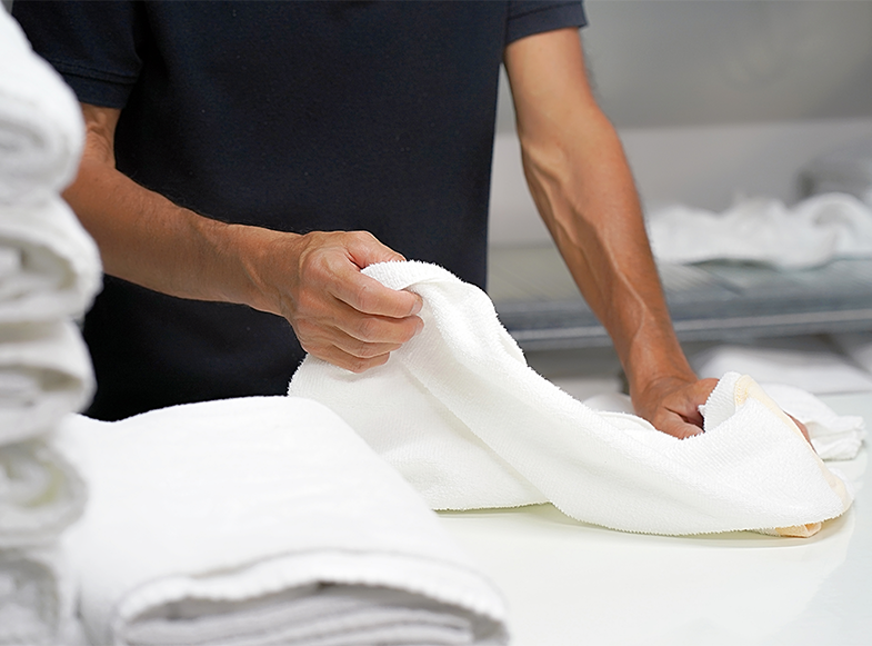 man folding towels