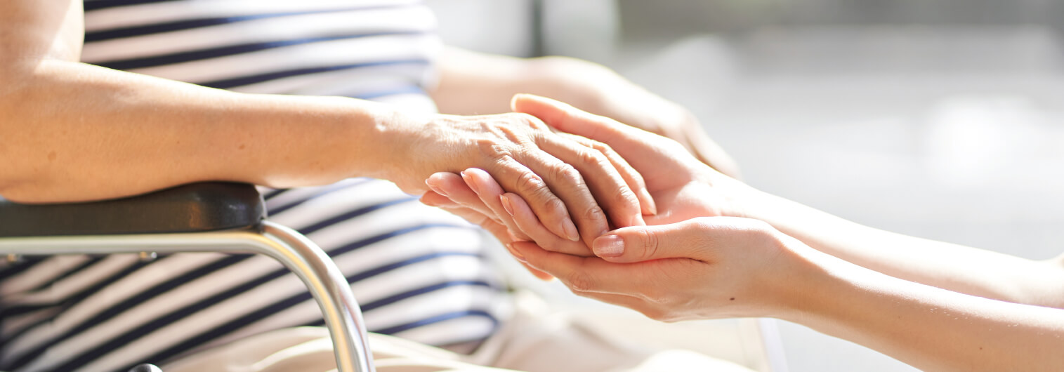 holding senior woman's hands